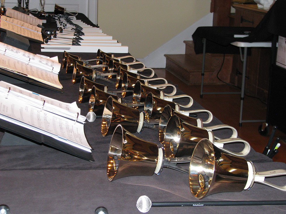 Bells on a table with sheet music