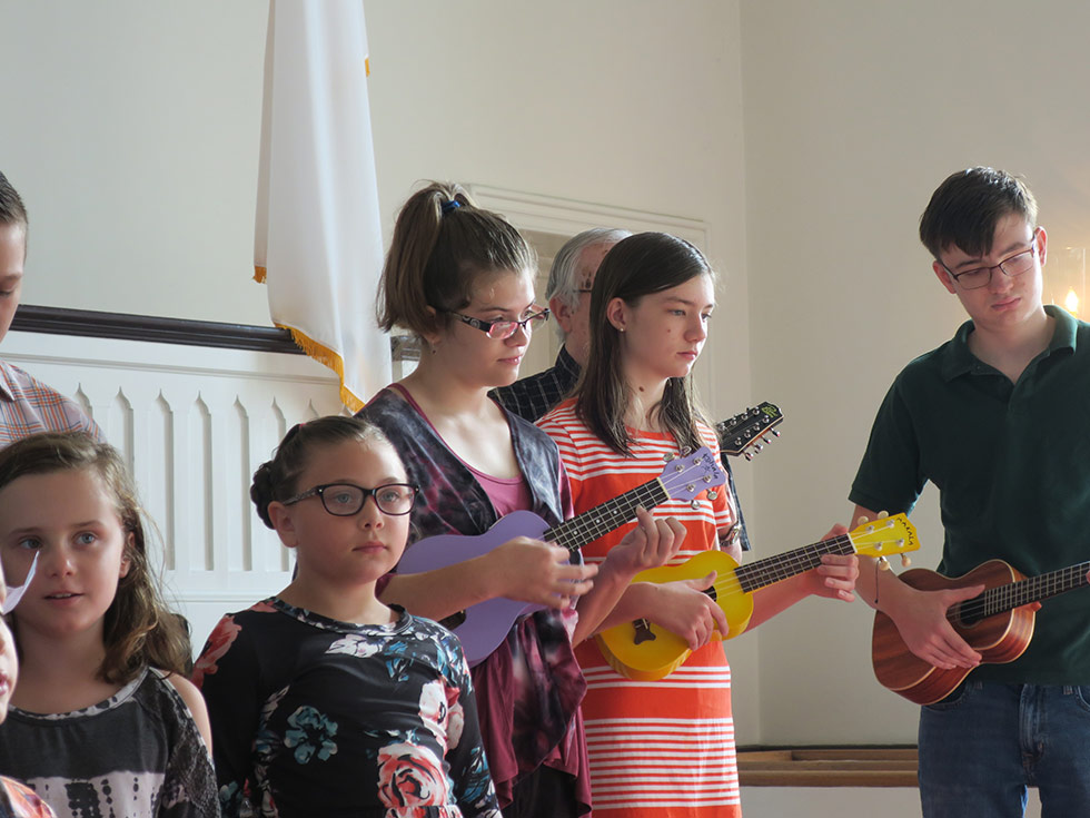 Children playing ukuleles during service