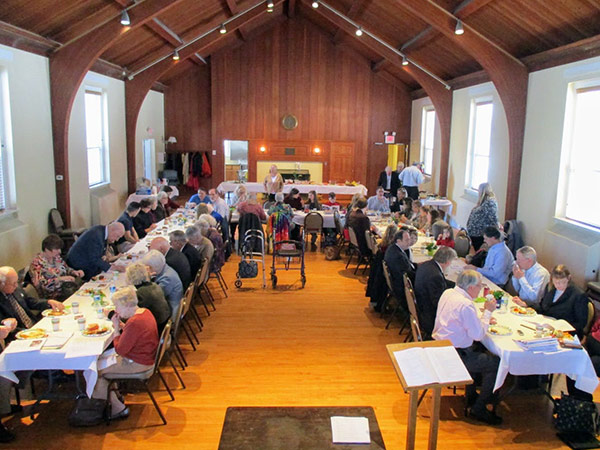 Church members having dinner in the Fellowship Hall