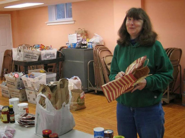 Carol Claypoole Director of Food Cupboard preparing a distribution