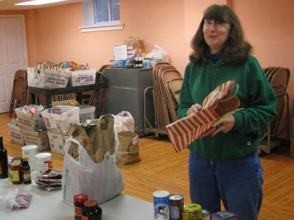 Carol Claypoole Director of Food Cupboard preparing a distribution