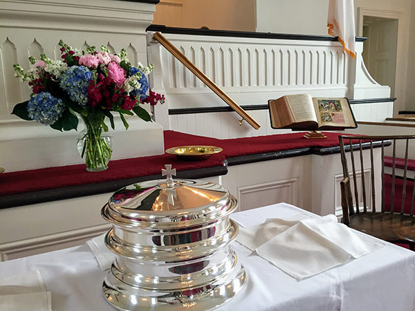 Communion trays at the alter with flowers