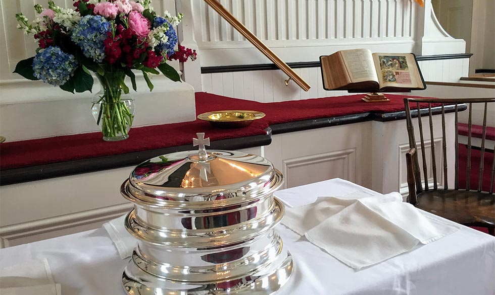 Communion trays at the alter with flowers