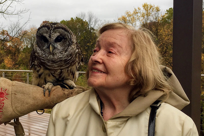 Photo of Irene Campbell with an owl from a 2019 excursion to the Audubon Nature Preserve