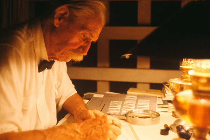 Photo of Albert Schweitzer writing at a desk