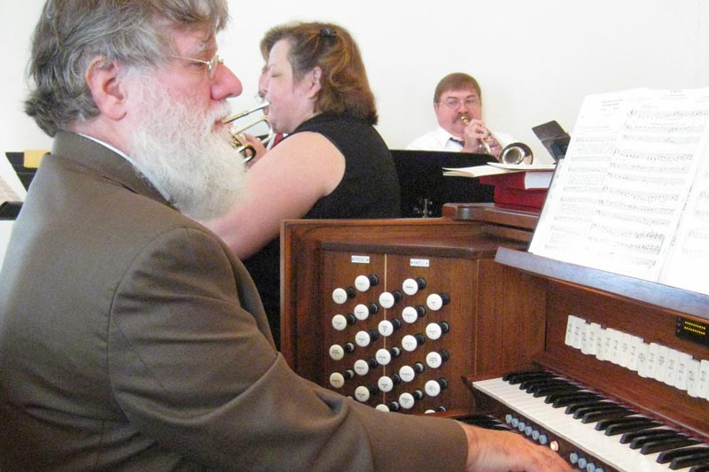 Photo of Charlie Confer playing the organ