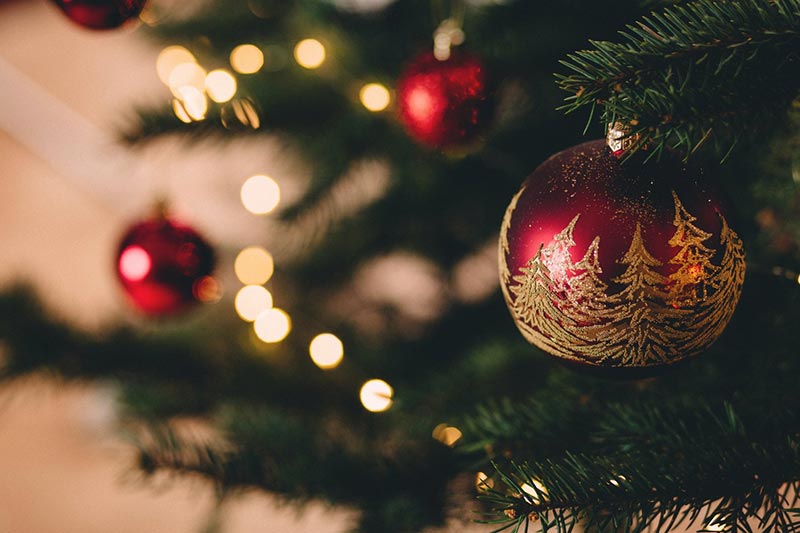 Photo of red and gold Christmas bulbs on a tree