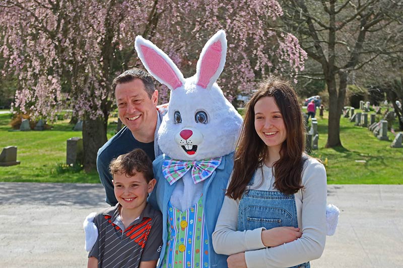 Photo of people posing with the Easter Bunny