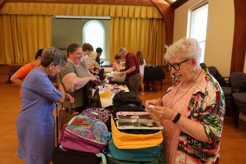 Photo of people packing backpacks