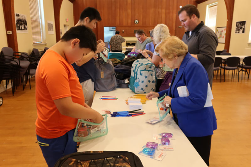 Photo of people packing backpacks