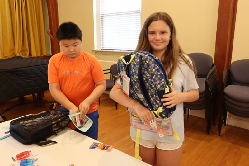 Photo of kids packing backpacks