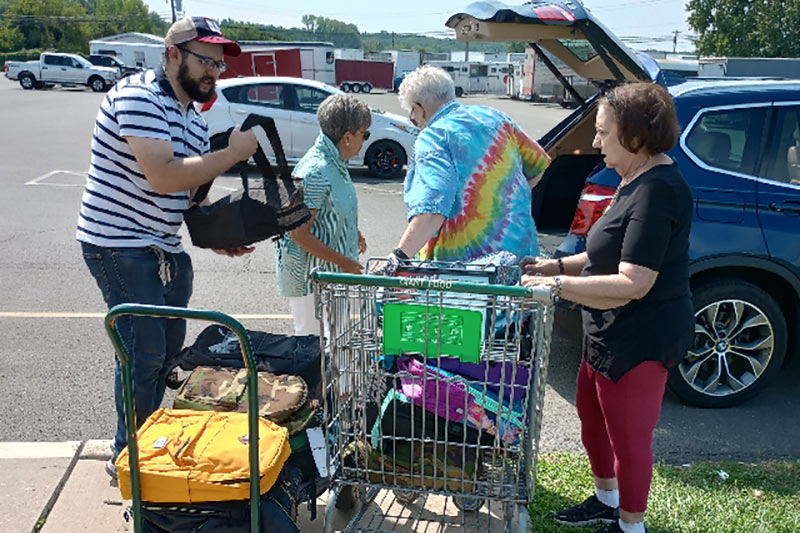 Photo of people delivering backpacks