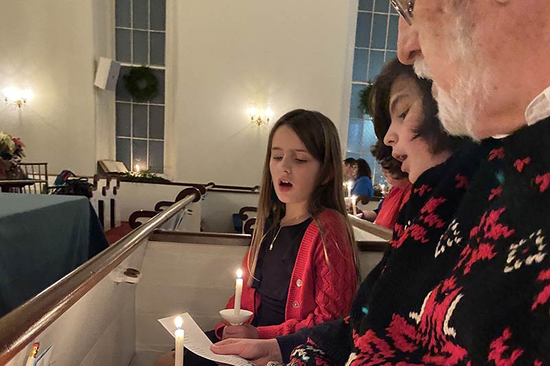 Attendees singing at the Christmas eve service