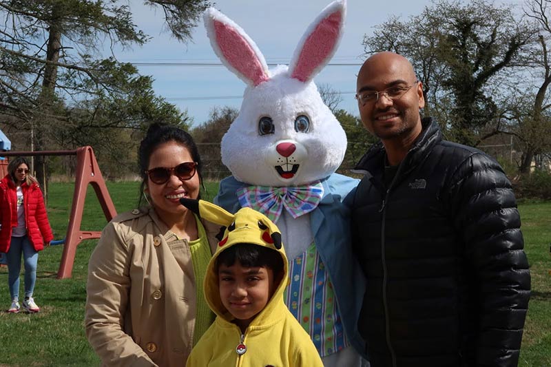 Photo of people posing with the Easter Bunny