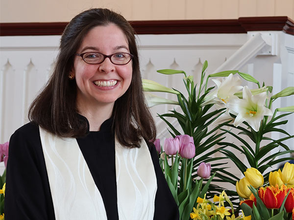 Photo of Reverend Rebecca Mygatt standing in the church on Easter Sunday