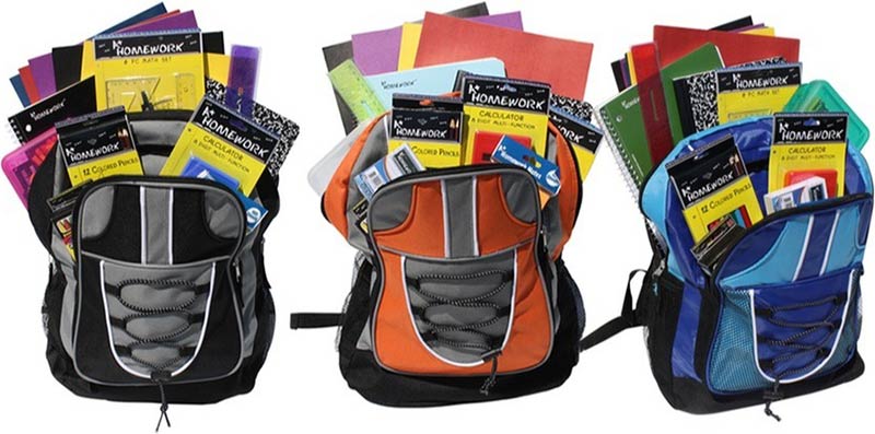 Photo of three backpacks stuffed with school supplies