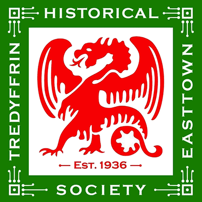 Tredyffrin Easttown Historical Society Logo - White serif type inside green square border with red dragon icon in center