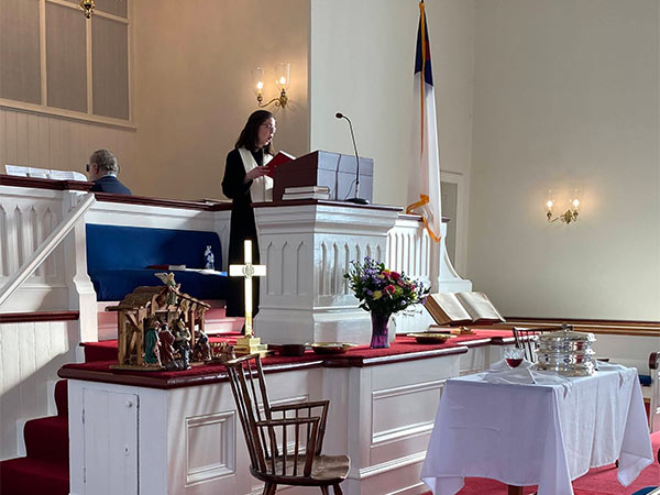 Photo of Reverend Rebecca Mygatt giving a sermon in the church on Sunday