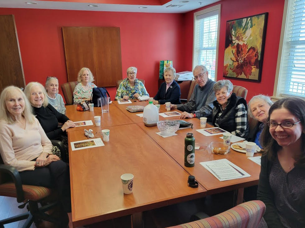 Photo of Reverend Rebecca Mygatt with church members at a luncheon