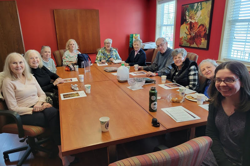 Photo of Reverend Rebecca Mygatt with church members at a luncheon