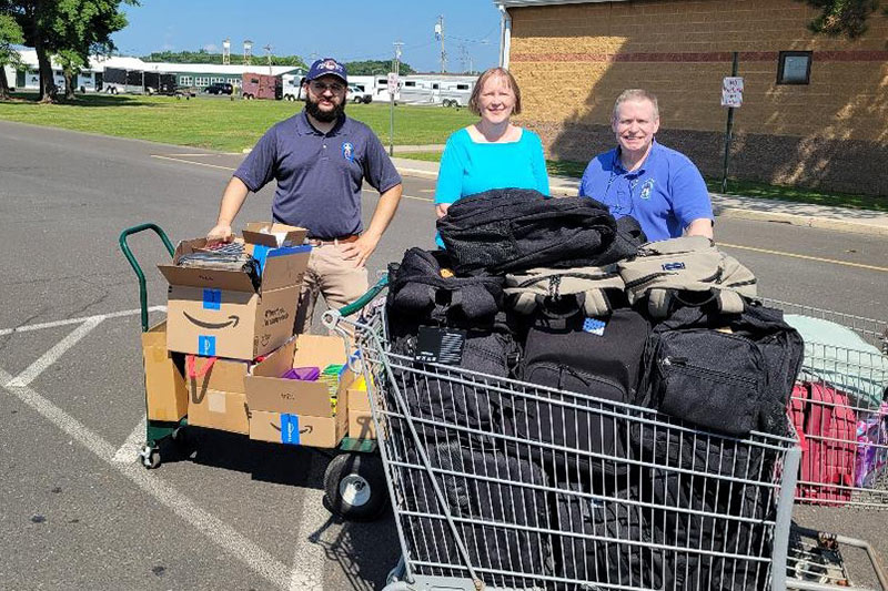 Photo of church members dropping off backpacks for students